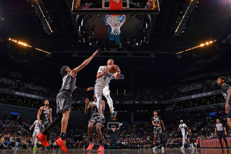 BROOKLYN, NY - DECEMBER 1: Jalen Suggs #4 of the Orlando Magic drives to the basket during the game against the Brooklyn Nets on December 1, 2024 at Barclays Center in Brooklyn, New York. NOTE TO USER: User expressly acknowledges and agrees that, by downloading and or using this Photograph, user is consenting to the terms and conditions of the Getty Images License Agreement. Mandatory Copyright Notice: Copyright 2024 NBAE (Photo by Jesse D. Garrabrant/NBAE via Getty Images)