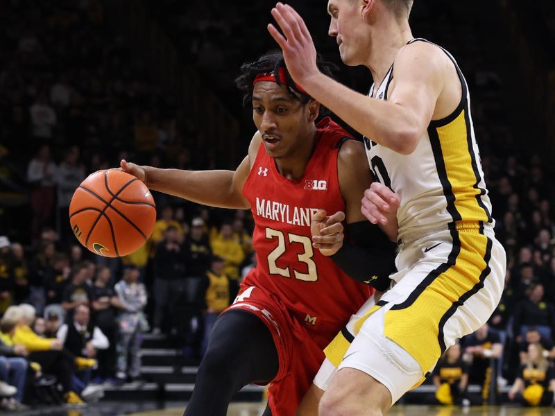 Jan 15, 2023; Iowa City, Iowa, USA; Maryland Terrapins guard Ian Martinez (23) is defended by Iowa Hawkeyes forward Patrick McCaffery (22) at Carver-Hawkeye Arena. Mandatory Credit: Reese Strickland-USA TODAY Sports