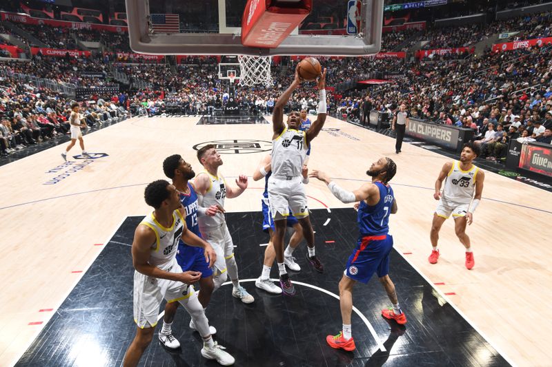 LOS ANGELES, CA - APRIL 5:  Kris Dunn #11 of the Utah Jazz goes to the basket during the game on April 5, 2024 at Crypto.Com Arena in Los Angeles, California. NOTE TO USER: User expressly acknowledges and agrees that, by downloading and/or using this Photograph, user is consenting to the terms and conditions of the Getty Images License Agreement. Mandatory Copyright Notice: Copyright 2024 NBAE (Photo by Adam Pantozzi/NBAE via Getty Images)