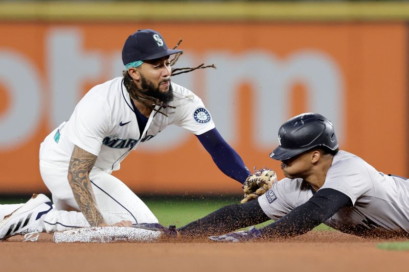 Sep 18, 2024; Seattle, Washington, USA; New York Yankees right fielder Juan Soto (22) reaches second base safely with a double as Seattle Mariners shortstop J.P. Crawford (3) can’t get the tag on time during the third inning at T-Mobile Park. Mandatory Credit: John Froschauer-Imagn Images