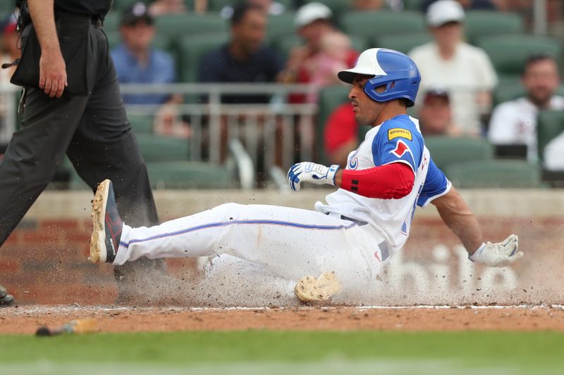 Jun 15, 2024; Cumberland, Georgia, USA; Atlanta Braves right fielder Ramon Laureano (18) slides into home against the Tampa Bay Rays during the eighth inning at Truist Park. Mandatory Credit: Mady Mertens-USA TODAY Sports