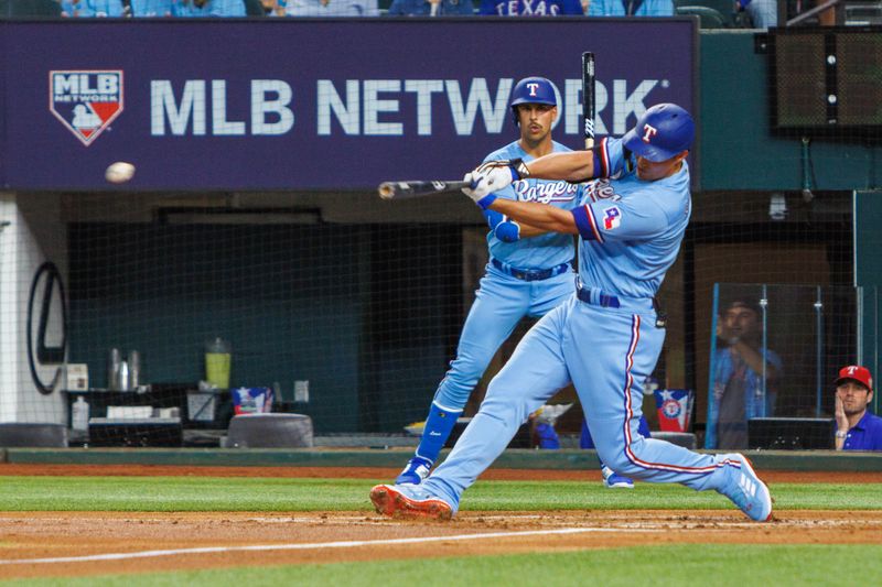 Apr 2, 2023; Arlington, Texas, USA; Texas Rangers shortstop Corey Seager (5) hits a single  during the first inning against the Philadelphia Phillies at Globe Life Field. Mandatory Credit: Andrew Dieb-USA TODAY Sports