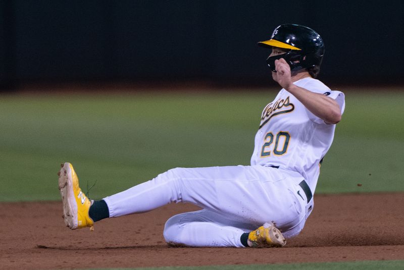 Sep 18, 2023; Oakland, California, USA;  Oakland Athletics second baseman Zack Gelof (20) slides into second during the third inning against the Seattle Mariners at Oakland-Alameda County Coliseum. Mandatory Credit: Stan Szeto-USA TODAY Sports