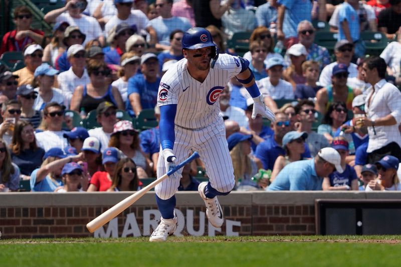 Aug 6, 2025; Chicago, Illinois, USA;  Chicago Cubs second base Nico Hoerner (2) hits a single against the Cincinnati Reds during the third inning at Wrigley Field. Mandatory Credit: David Banks-Imagn Images