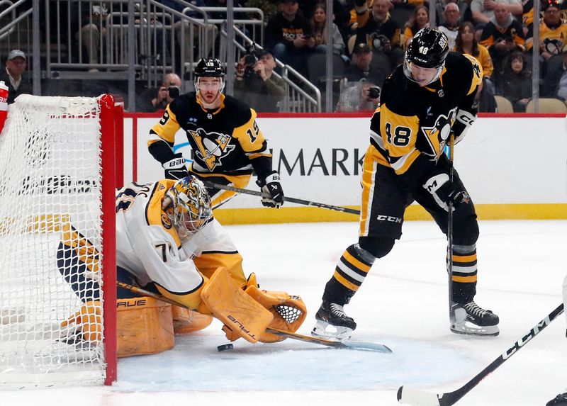 Apr 15, 2024; Pittsburgh, Pennsylvania, USA;  Nashville Predators goaltender Juuse Saros (74) makes a save against Pittsburgh Penguins right wing Valtteri Puustinen (48) during the first period at PPG Paints Arena. The Penguins won 4-2.  Mandatory Credit: Charles LeClaire-USA TODAY Sports