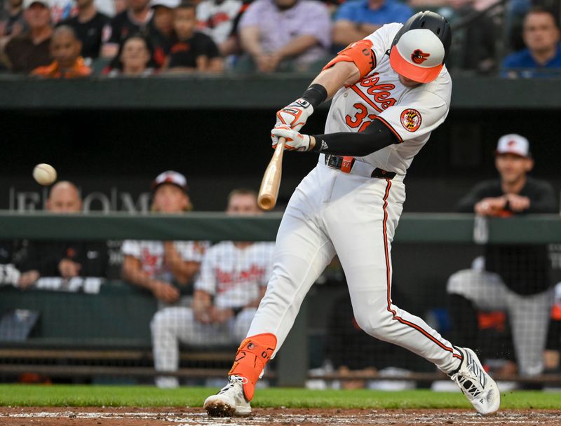 Apr 16, 2024; Baltimore, Maryland, USA;  Baltimore Orioles first baseman Ryan O'Hearn (32) hits a third inning single against the Minnesota Twins at Oriole Park at Camden Yards. Mandatory Credit: Tommy Gilligan-USA TODAY Sports