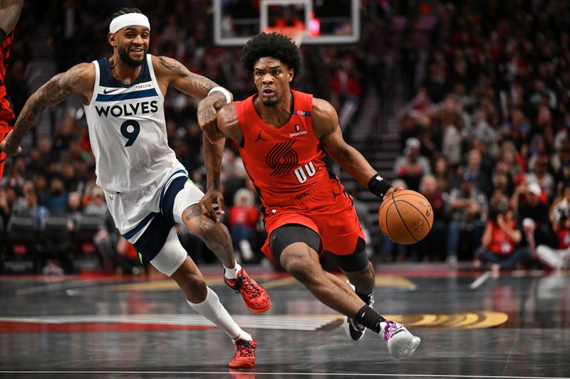 PORTLAND, OREGON - NOVEMBER 12: Scoot Henderson #00 of the Portland Trail Blazers dribbles against Nickeil Alexander-Walker #9 of the Minnesota Timberwolves during the third quarter of the Emirates NBA Cup game at Moda Center on November 12, 2024 in Portland, Oregon. The Portland Trail Blazers won 122-108. NOTE TO USER: User expressly acknowledges and agrees that, by downloading and or using this photograph, User is consenting to the terms and conditions of the Getty Images License Agreement. (Photo by Alika Jenner/Getty Images)