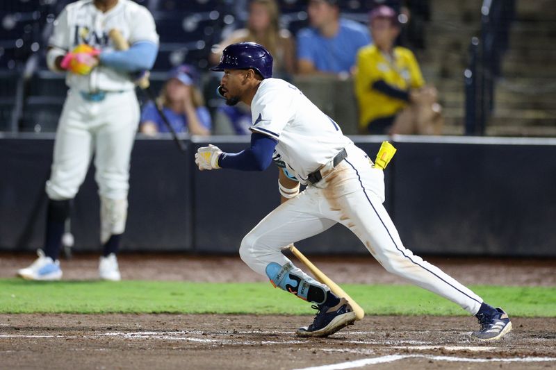 Sep 17, 2025; Tampa, Florida, USA; Tampa Bay Rays center fielder Chandler Simpson (14) doubles against the Toronto Blue Jays in the fifth inning at George M. Steinbrenner Field. Mandatory Credit: Nathan Ray Seebeck-Imagn Images