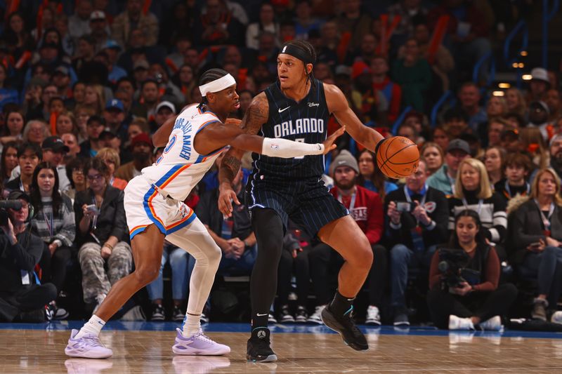 OKLAHOMA CITY, OK - JANUARY 13: Paolo Banchero #5 of the Orlando Magic handles the ball during the game against the Oklahoma City Thunder  on January 13, 2024 at Paycom Arena in Oklahoma City, Oklahoma. NOTE TO USER: User expressly acknowledges and agrees that, by downloading and or using this photograph, User is consenting to the terms and conditions of the Getty Images License Agreement. Mandatory Copyright Notice: Copyright 2024 NBAE (Photo by Zach Beeker/NBAE via Getty Images)