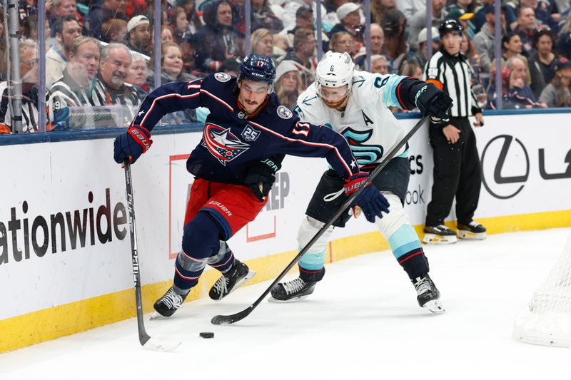 Mar 21, 2026; Columbus, Ohio, USA; Columbus Blue Jackets left wing Mason Marchment (17) and Seattle Kraken defenseman Adam Larsson (6) battle for the puck during the second period at Nationwide Arena. Mandatory Credit: Russell LaBounty-Imagn Images