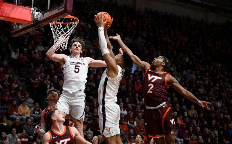 Feb 4, 2023; Blacksburg, Virginia, USA; Virginia Cavaliers forward Jayden Gardner (1) drives to basket as Virginia Tech Hokies guard Michael Collins Jr. (2) defends at Cassell Coliseum in the first half. Mandatory Credit: Lee Luther Jr.-USA TODAY Sports