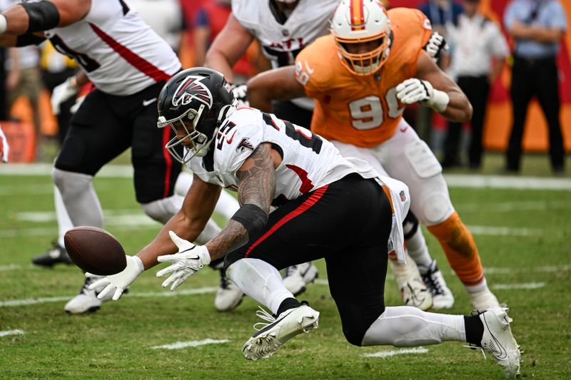 Atlanta Falcons running back Tyler Allgeier (25) fumbles the ball against the Tampa Bay Buccaneers during the second half of an NFL football game, Sunday, Oct. 27, 2024, in Tampa. The Tampa Bay Buccaneers recovered the ball for a safety. (AP Photo/Jason Behnken)