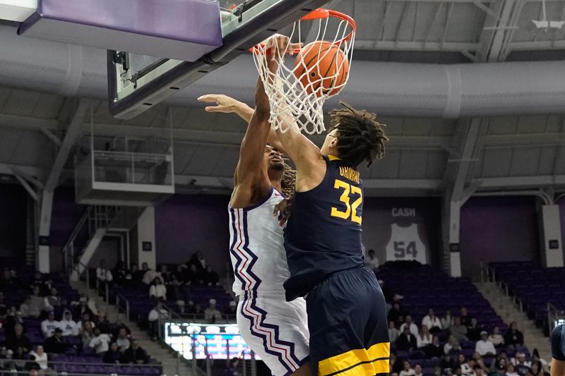 Jan 31, 2023; Fort Worth, Texas, USA; TCU Horned Frogs forward Xavier Cork (12) dunks the ball against West Virginia Mountaineers forward James Okonkwo (32) during the first half at Ed and Rae Schollmaier Arena. Mandatory Credit: Chris Jones-USA TODAY Sports