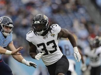 Jacksonville Jaguars linebacker Devin Lloyd (33) defends during the second half of an NFL football game against the Tennessee Titans, Sunday, Dec. 8, 2024, in Nashville, Tenn. (AP Photo/Stew Milne)