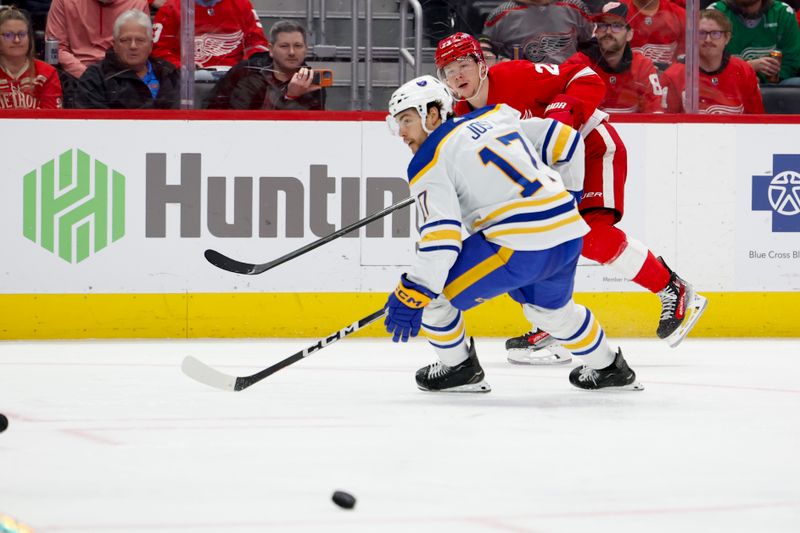 Mar 16, 2024; Detroit, Michigan, USA;  Detroit Red Wings left wing Lucas Raymond (23) Buffalo Sabres center Tyson Jost (17) in the second period at Little Caesars Arena. Mandatory Credit: Rick Osentoski-USA TODAY Sports