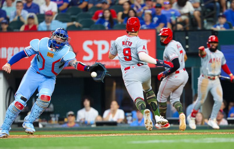 May 19, 2024; Arlington, Texas, USA; Los Angeles Angels shortstop Zach Neto (9) scores ahead of the tag by Texas Rangers catcher Jonah Heim (28) during the seventh inning at Globe Life Field. Mandatory Credit: Kevin Jairaj-USA TODAY Sports