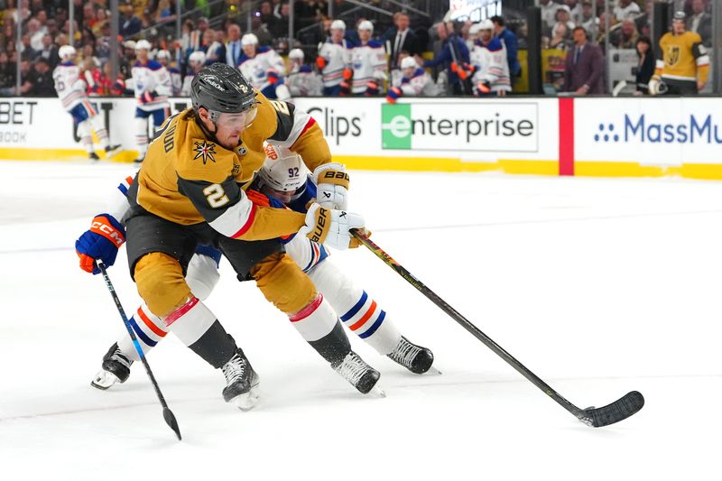 May 14, 2025; Las Vegas, Nevada, USA; Vegas Golden Knights defenseman Zach Whitecloud (2) protects the puck from Edmonton Oilers right wing Vasily Podkolzin (92) during the first period of game five of the second round of the 2025 Stanley Cup Playoffs at T-Mobile Arena. Mandatory Credit: Stephen R. Sylvanie-Imagn Images