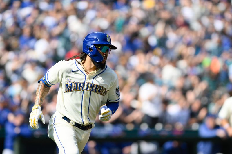 Sep 17, 2023; Seattle, Washington, USA; Seattle Mariners shortstop J.P. Crawford (3) runs towards first base after hitting an RBI single against the Los Angeles Dodgers during the second inning at T-Mobile Park. Mandatory Credit: Steven Bisig-USA TODAY Sports