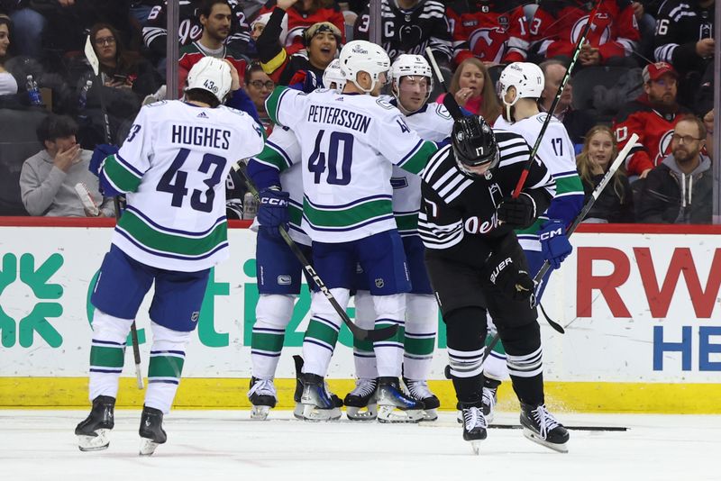 Jan 6, 2024; Newark, New Jersey, USA; Vancouver Canucks center J.T. Miller (9) celebrates his goal against the New Jersey Devils during the second period at Prudential Center. Mandatory Credit: Ed Mulholland-USA TODAY Sports