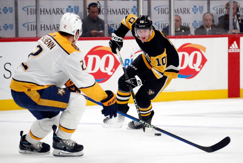 Apr 15, 2024; Pittsburgh, Pennsylvania, USA;  Pittsburgh Penguins left wing Drew O'Connor (10) skates with the puck as Nashville Predators defenseman Luke Schenn (2) defends during the first period  at PPG Paints Arena. Mandatory Credit: Charles LeClaire-USA TODAY Sports