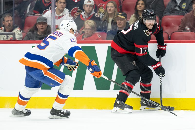 Nov 7, 2024; Ottawa, Ontario, CAN; Ottawa Senators right wing Zack MacEwen (17) moves the puck away from New York Islanders defenseman Dennis Cholowski (25) in the first period at the Canadian Tire Centre. Mandatory Credit: Marc DesRosiers-Imagn Images