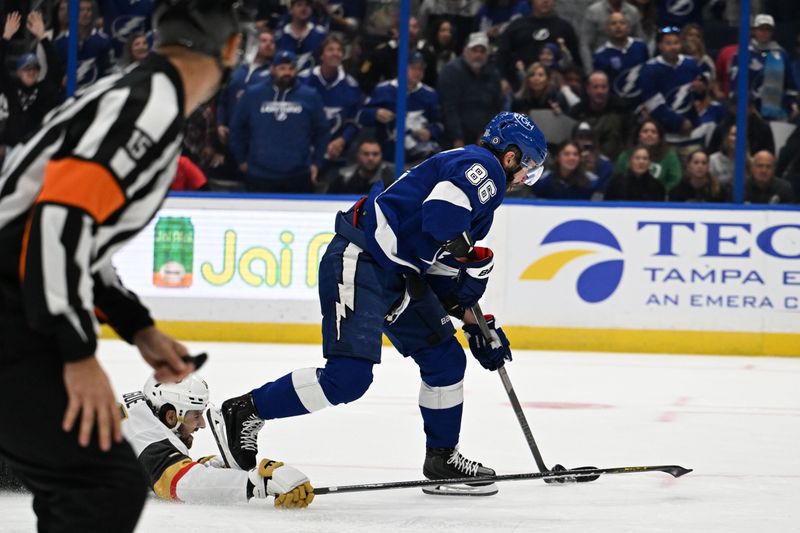 Dec 21, 2023; Tampa, Florida, USA; Tampa Bay Lightning right wing Nikita Kucherov (86) gets past Las Vegas Golden Knights defensemen Nicholas Hague (14) in the third period at Amalie Arena. Mandatory Credit: Jonathan Dyer-USA TODAY Sports