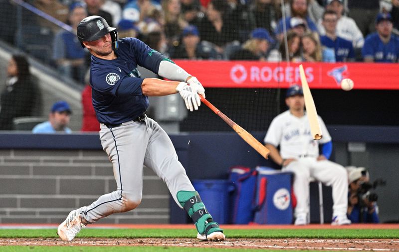 Apr 8, 2024; Toronto, Ontario, CAN;  Seattle mariners first baseman Ty France (23) breaks his bat as he hits a single against the Toronto Blue Jays in the seventh inning at Rogers Centre. Mandatory Credit: Dan Hamilton-USA TODAY Sports