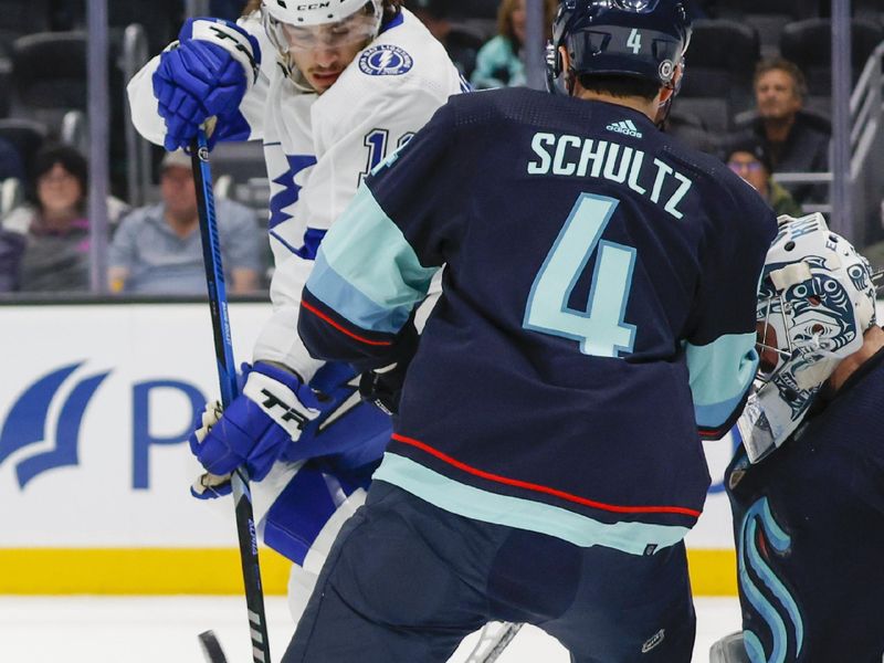 Dec 9, 2023; Seattle, Washington, USA; Tampa Bay Lightning center Alex Barre-Boulet (12) gets out of the way of the puck after a shot by Tampa Bay Lightning center Anthony Cirelli (71) for a goal against Seattle Kraken goaltender Philipp Grubauer (31, right) during the first period at Climate Pledge Arena. Mandatory Credit: Joe Nicholson-USA TODAY Sports