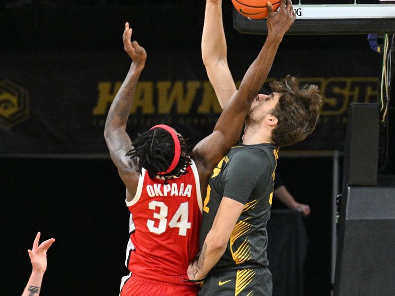 Feb 2, 2024; Iowa City, Iowa, USA; Iowa Hawkeyes forward Owen Freeman (32) blocks the shot of Ohio State Buckeyes center Felix Okpara (34) during the second half at Carver-Hawkeye Arena. Mandatory Credit: Jeffrey Becker-USA TODAY Sports