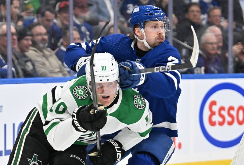 Feb 7, 2024; Toronto, Ontario, CAN; Toronto Maple Leafs defenseman Simon Benoit (2) covers Dallas Stars forward Ty Dellandrea (10) in the second period at Scotiabank Arena. Mandatory Credit: Dan Hamilton-USA TODAY Sports