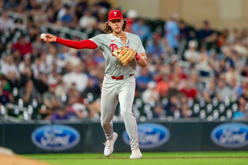 Jul 23, 2024; Minneapolis, Minnesota, USA; Philadelphia Phillies third baseman Alec Bohm (28) throws the ball to first base for an out against the Minnesota Twins in the ninth inning at Target Field. Mandatory Credit: Jesse Johnson-USA TODAY Sports