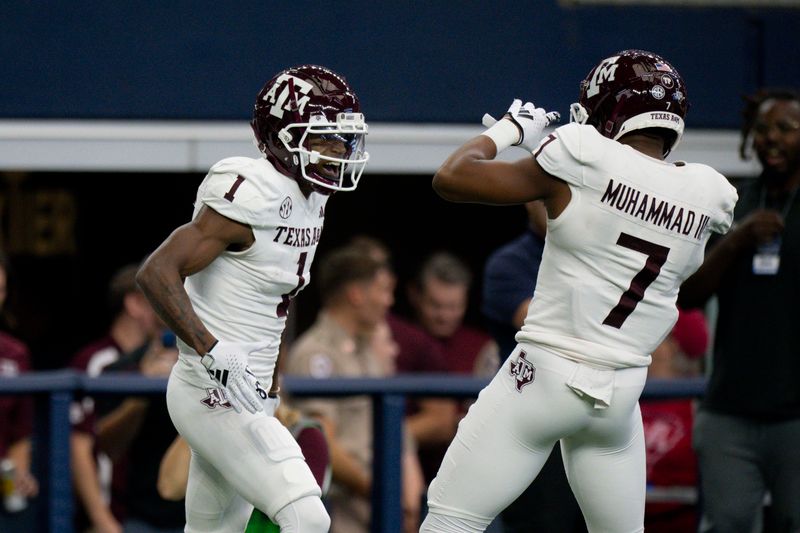 Sep 30, 2023; Arlington, Texas, USA; Texas A&M Aggies wide receiver Evan Stewart (1) and wide receiver Moose Muhammad III (7) celebrate after Stewart catches a pass for a touchdown against the Arkansas Razorbacks during the first half at AT&T Stadium. Mandatory Credit: Jerome Miron-USA TODAY Sports