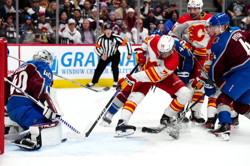 Dec 11, 2023; Denver, Colorado, USA; Calgary Flames center Martin Pospisil (76) shoots the puck at Colorado Avalanche goaltender Alexandar Georgiev (40) in the first period at Ball Arena. Mandatory Credit: Ron Chenoy-USA TODAY Sports