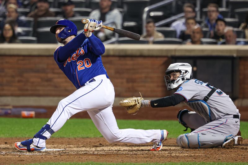 Sep 27, 2023; New York, NY, USA; New York Mets first baseman Pete Alonso (20) doubles during the eighth inning in front of Miami Marlins catcher Jacob Stallings (58) at Citi Field.  Mandatory Credit: Vincent Carchietta-USA TODAY Sports