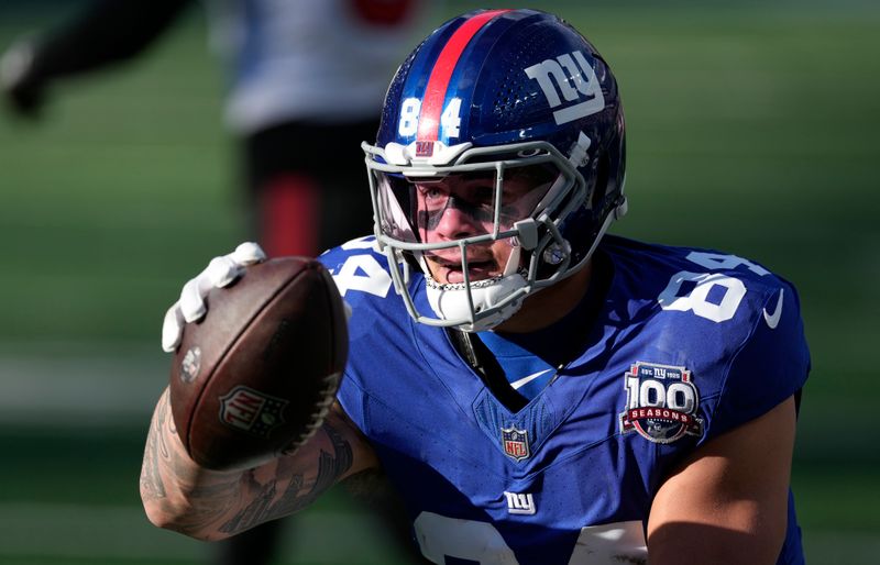 New York Giants tight end Theo Johnson (84) celebrates a first down against the Tampa Bay Buccaneers during the first half of an NFL football game Sunday, Nov. 24, 2024, in East Rutherford, N.J. (AP Photo/Seth Wenig)