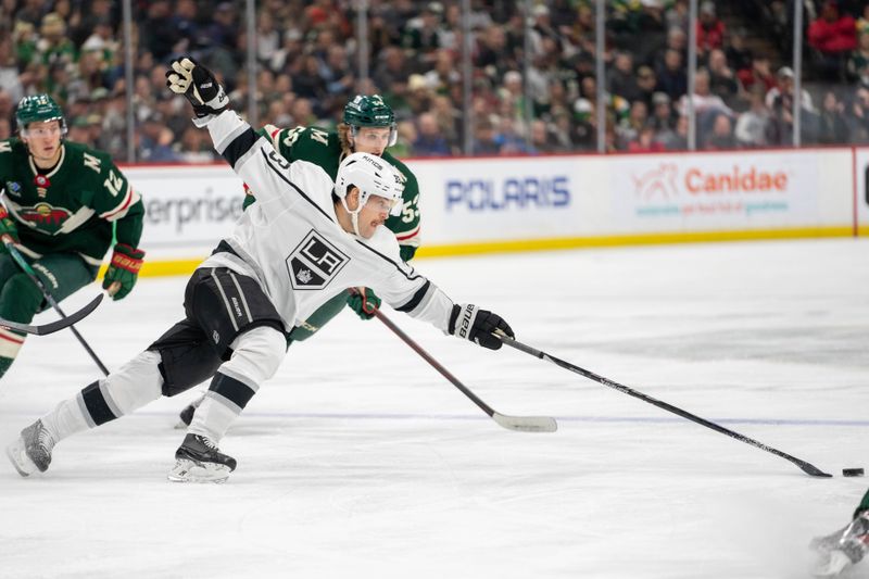 Feb 21, 2023; Saint Paul, Minnesota, USA; Los Angeles Kings right wing Viktor Arvidsson (33) reaches for a loose puck, chased by Minnesota Wild left wing Adam Beckman (53) and left wing Matt Boldy (12) in the third period at Xcel Energy Center. Mandatory Credit: Matt Blewett-USA TODAY Sports