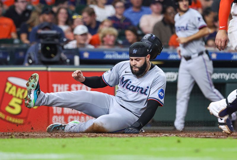 Jul 10, 2024; Houston, Texas, USA; Miami Marlins third baseman Emmanuel Rivera (15) slides safely to score a run during the fifth inning against the Houston Astros at Minute Maid Park. Mandatory Credit: Troy Taormina-USA TODAY Sports