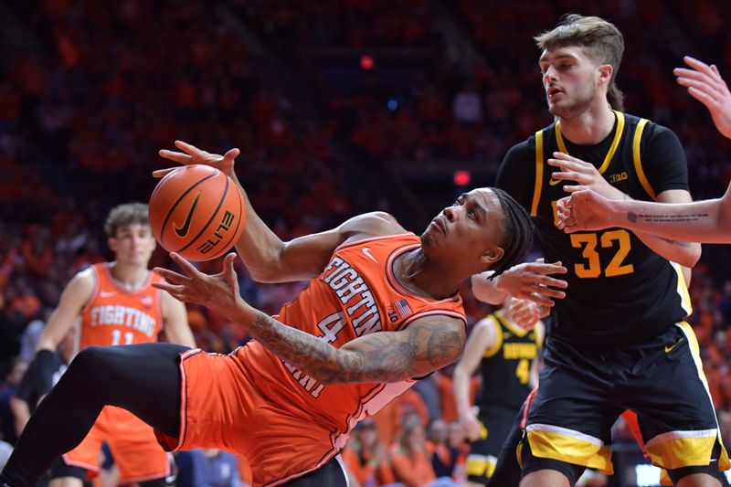 Feb 24, 2024; Champaign, Illinois, USA;  Illinois Fighting Illini guard Justin Harmon (4) pulls downs a rebound in front of Iowa Hawkeyes forward Owen Freeman (32) during the second half at State Farm Center. Mandatory Credit: Ron Johnson-USA TODAY Sports