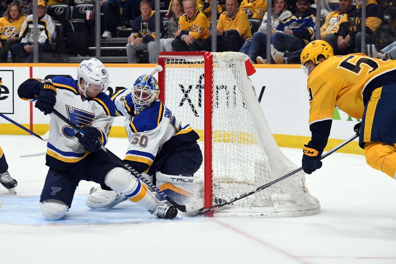 Apr 4, 2024; Nashville, Tennessee, USA; Nashville Predators defenseman Roman Josi (59) has a wrap around attempt stopped by St. Louis Blues defenseman Torey Krug (47) and goaltender Jordan Binnington (50) during the third period at Bridgestone Arena. Mandatory Credit: Christopher Hanewinckel-USA TODAY Sports