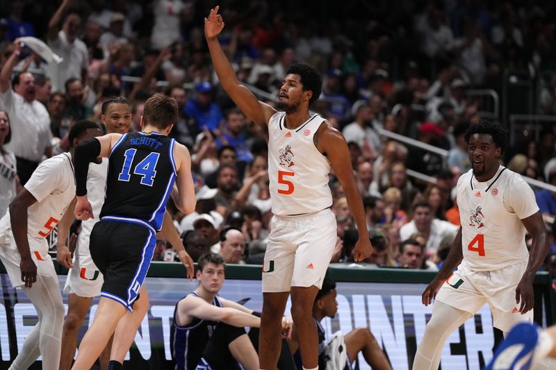 Feb 6, 2023; Coral Gables, Florida, USA; Miami Hurricanes guard Harlond Beverly (5) gestures after making a three point shot against the Duke Blue Devils during the second half at Watsco Center. Mandatory Credit: Jasen Vinlove-USA TODAY Sports