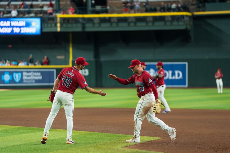 Apr 14, 2024; Phoenix, Arizona, USA; Arizona Diamondbacks infielder Christian Walker (53) and pitcher Bryce Jarvis (40) celebrate after beating the St. Louis Cardinals 5-0 at Chase Field. Mandatory Credit: Allan Henry-USA TODAY Sports