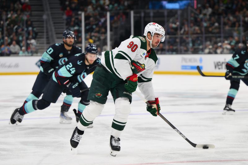 Dec 10, 2023; Seattle, Washington, USA; Minnesota Wild left wing Marcus Johansson (90) passes the puck against the Seattle Kraken during the third period at Climate Pledge Arena. Mandatory Credit: Steven Bisig-USA TODAY Sports