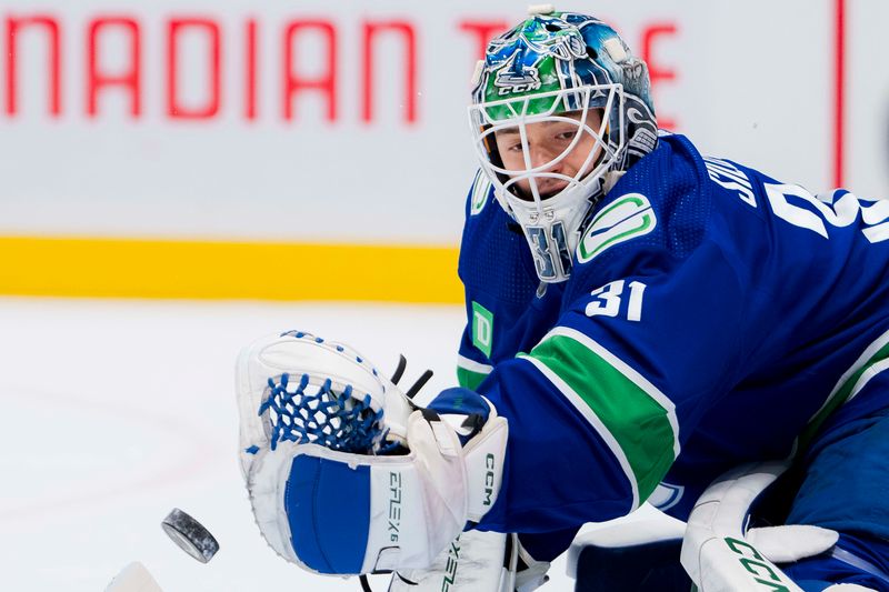 Mar 13, 2024; Vancouver, British Columbia, CAN; Vancouver Canucks goalie Arturs Silvos (31) makes a save during warm up prior to a game against the Colorado Avalanche at Rogers Arena. Mandatory Credit: Bob Frid-USA TODAY Sports