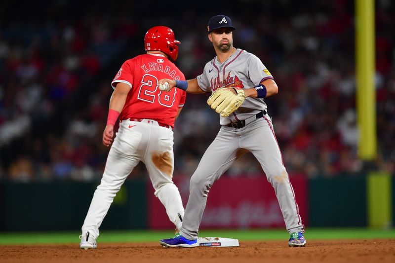 August 16, 2024; Anaheim, California, USA; Los Angeles Angels designated hitter Niko Kavadas (28) is out at second by Atlanta Braves second baseman Whit Merrifield (15) during the sixth inning at Angel Stadium. Mandatory Credit: Gary A. Vasquez-USA TODAY Sports