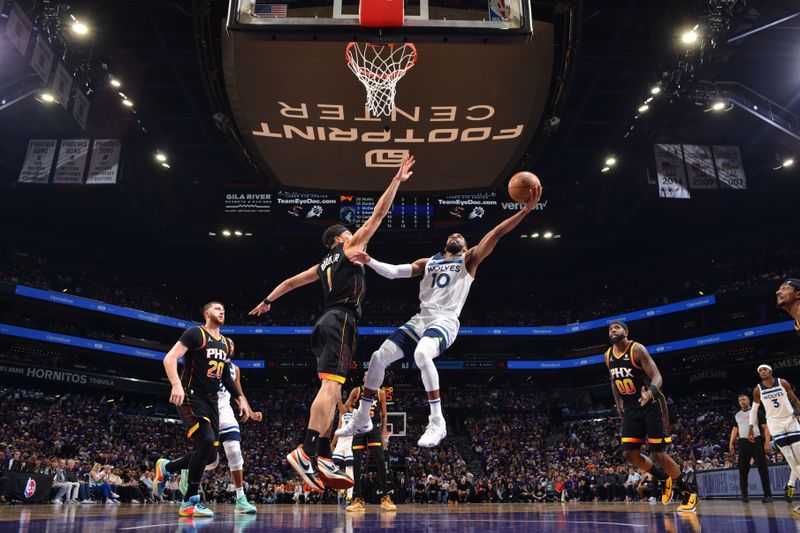 PHOENIX, AZ - APRIL 26:  Mike Conley #10 of the Minnesota Timberwolves drives to the basket during the game against the Phoenix Suns during Round 1 Game 3 of the 2024 NBA Playoffs on April 26, 2024 at Footprint Center in Phoenix, Arizona. NOTE TO USER: User expressly acknowledges and agrees that, by downloading and or using this photograph, user is consenting to the terms and conditions of the Getty Images License Agreement. Mandatory Copyright Notice: Copyright 2024 NBAE (Photo by Barry Gossage/NBAE via Getty Images)