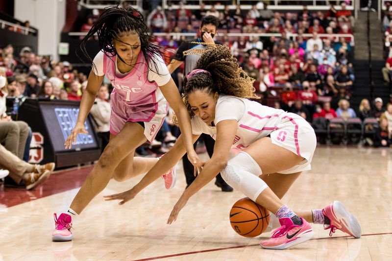 Feb 17, 2023; Stanford, California, USA;  Stanford Cardinal guard Haley Jones (30) and USC Trojans guard Taylor Bigby (1) battle for possession during the second half at Maples Pavilion. Mandatory Credit: John Hefti-USA TODAY Sports