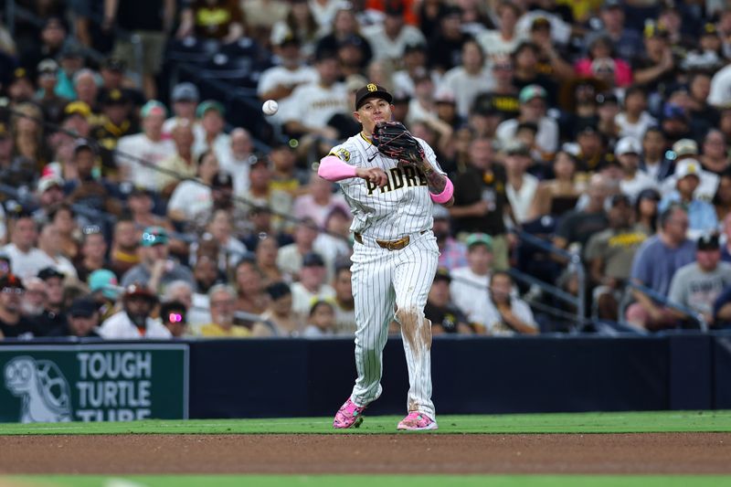 Sep 7, 2024; San Diego, California, USA; San Diego Padres third baseman Manny Machado (13) throws to retire San Francisco Giants center fielder Heliot Ramos (not pictured) on a ground ball in the seventh inning at Petco Park. Mandatory Credit: Chadd Cady-Imagn Images