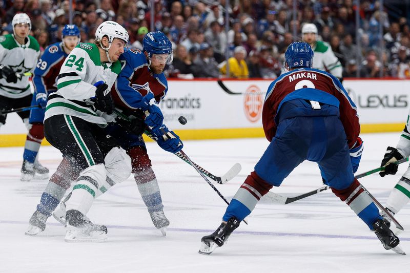 May 11, 2024; Denver, Colorado, USA; Dallas Stars center Roope Hintz (24) and Colorado Avalanche defenseman Devon Toews (7) battle for the puck as defenseman Cale Makar (8) defends in the third period in game three of the second round of the 2024 Stanley Cup Playoffs at Ball Arena. Mandatory Credit: Isaiah J. Downing-USA TODAY Sports