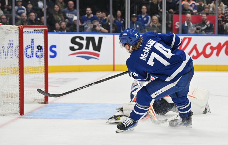 Nov 16, 2024; Toronto, Ontario, CAN;  Toronto Maple Leafs forward Bobby McMann (74) scores a goal against Edmonton Oilers goalie Stuart Skinner (74) in the third period at Scotiabank Arena. Mandatory Credit: Dan Hamilton-Imagn Images