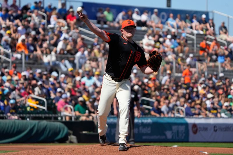 Mar 5, 2024; Scottsdale, Arizona, USA; San Francisco Giants starting pitcher Logan Webb (62) throws over to first base against the Milwaukee Brewers in the first inning at Scottsdale Stadium. Mandatory Credit: Rick Scuteri-USA TODAY Sports